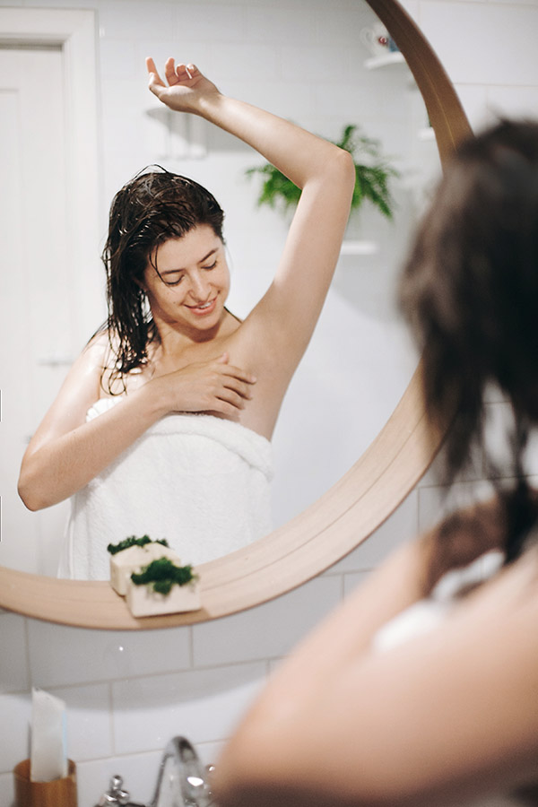 Young attractive woman with wet hair in white towel enjoying smo